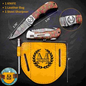 A red-and-gold striped folding knife with measurements is displayed above a yellow leather sheath and steel sharpener.